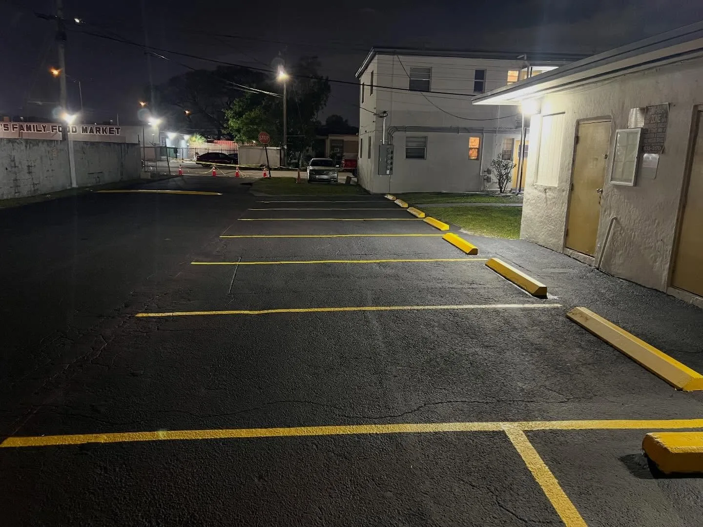 Freshly striped commercial parking lot with new wheel stops in Cutler Bay, FL